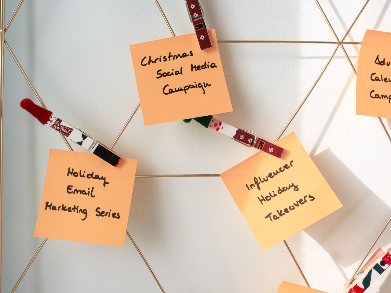 Sticky notes filled with Christmas marketing ideas for social media and email campaigns.